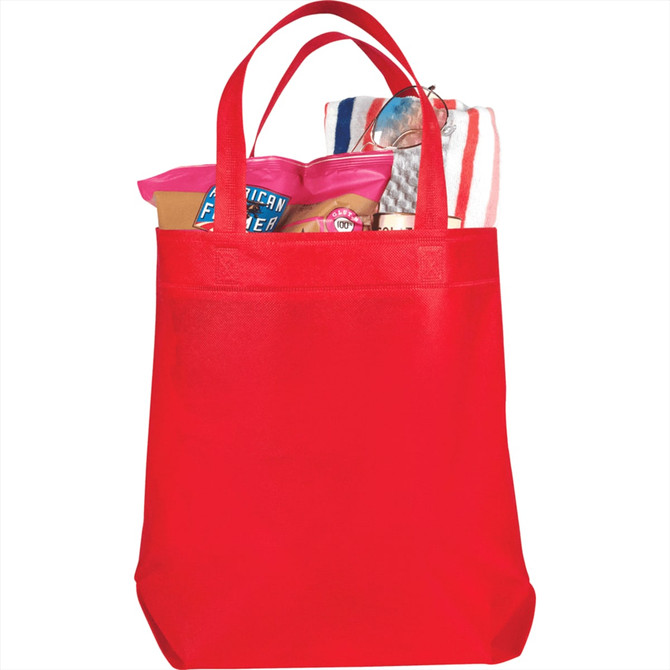 A red non-woven shopper tote filled with various items, including snacks and a towel, featuring a logo.