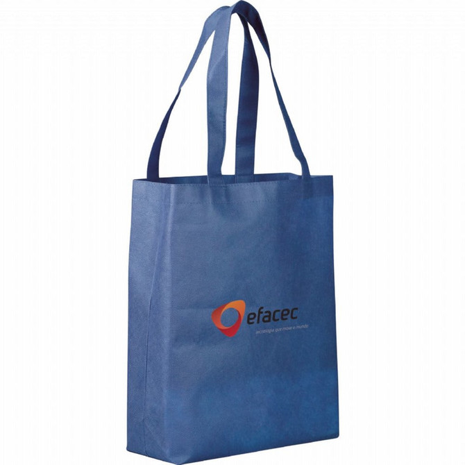 A blue non-woven tote bag with two handles and a logo on the front.