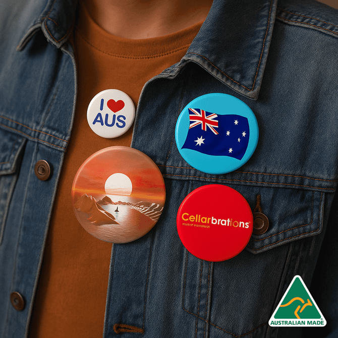 A collection of button badges in various colours, featuring illustrations and a logo, pinned to a denim jacket.