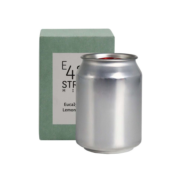 A silver can candle with a green packaging box, featuring a logo. The scent is eucalyptus and lemon.