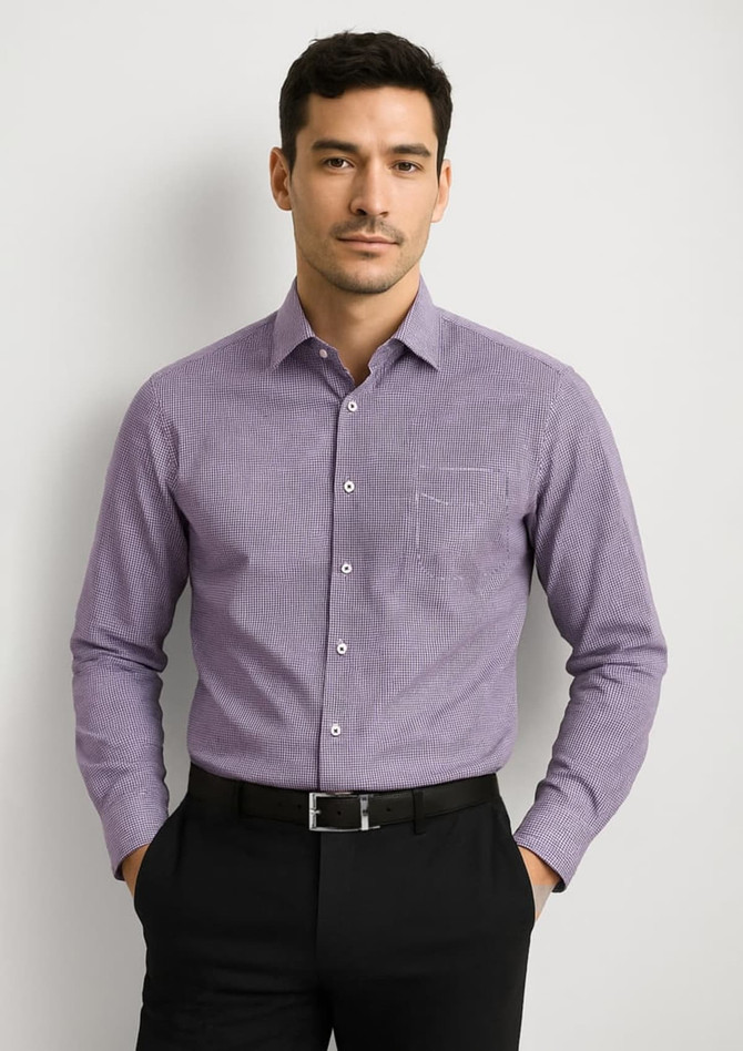 A men's long sleeve button-up shirt in purple with a pocket and a logo, worn by a model against a neutral background.