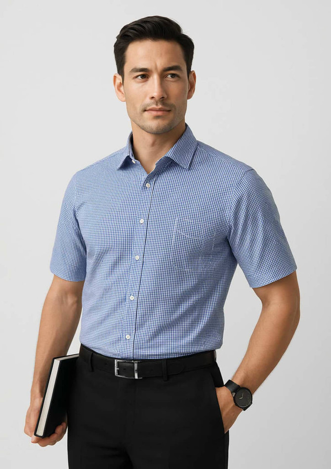 A short sleeve button-up shirt in a blue check pattern, paired with black trousers and a notebook.