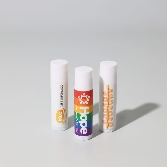 Three lip balm tubes in white packaging, featuring various coloured designs and logos.