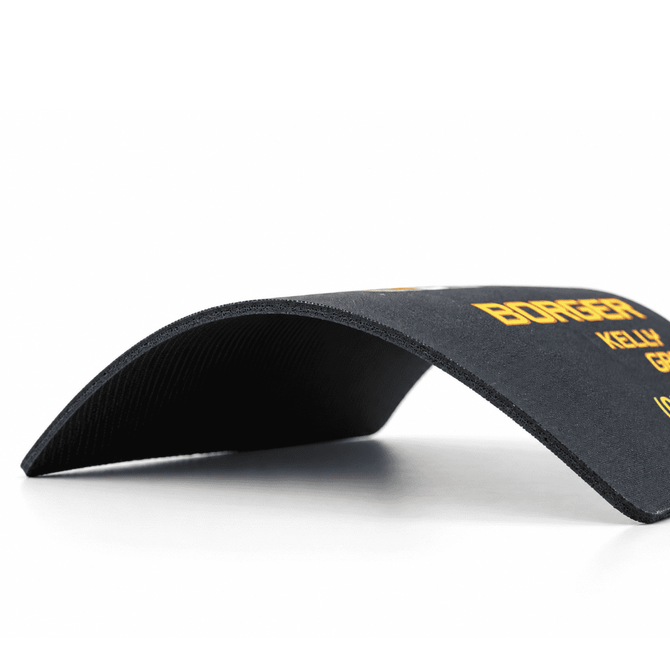 A black fabric mouse mat with a natural rubber base, featuring a slight curve. It has a logo printed on it.