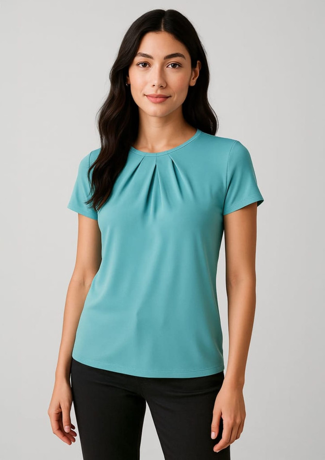 A short sleeve top in teal, featuring a pleated design, worn by a model against a light background.