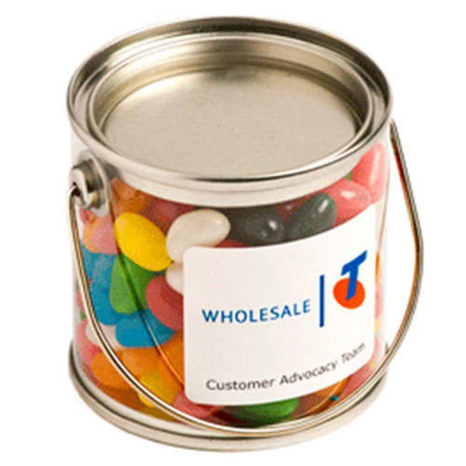 A small silver bucket filled with colourful mini jelly beans, featuring a branding label.