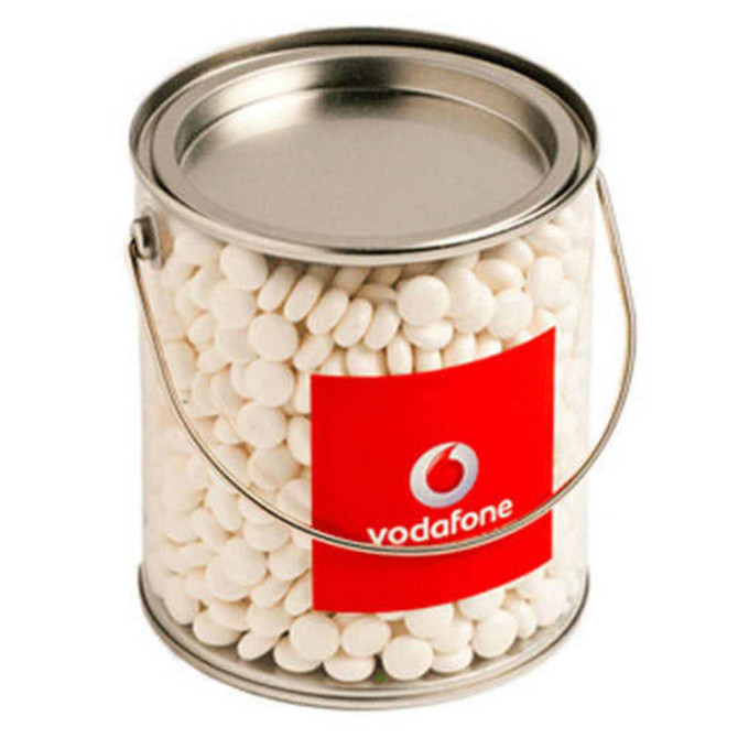 A tin bucket filled with white chewy mints and featuring a logo on the front.