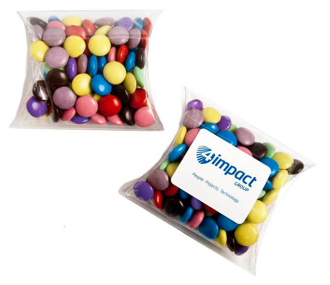 A pillow pack containing a variety of colourful choc beans in purple, yellow, green, red, and blue. It has a branding logo.