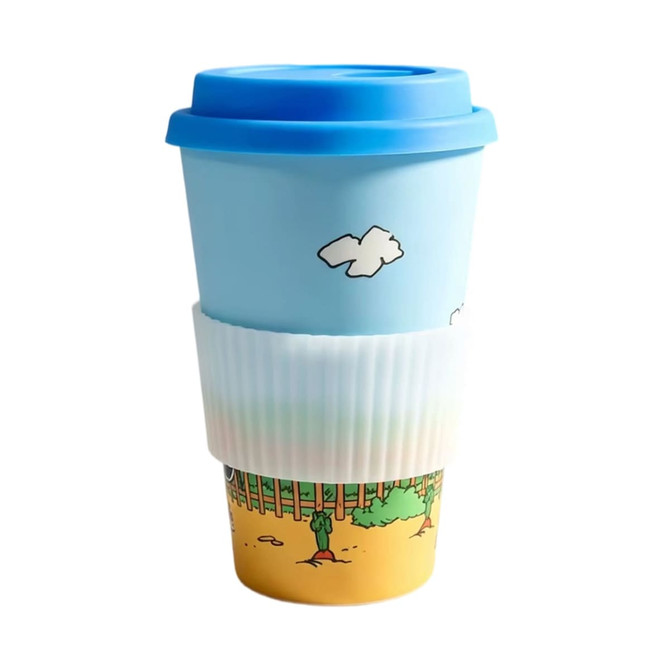 A reusable 400ml bamboo coffee cup in blue with a colourful design and a white silicone sleeve.