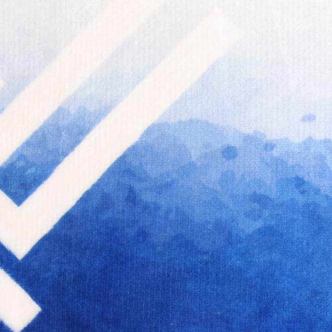 A textured mat featuring a gradient design in shades of blue, with a prominent logo displayed.