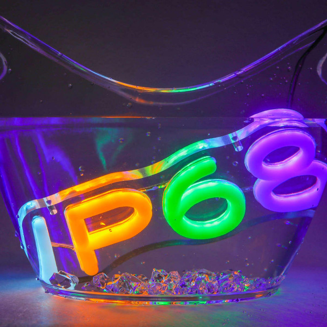 A clear container filled with water, featuring neon LED lights in orange, green, and purple displaying "IP68".