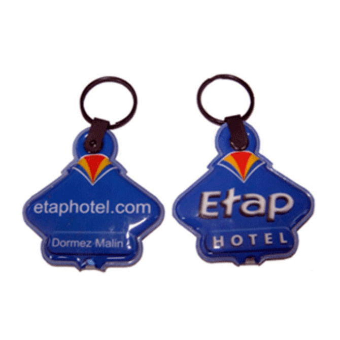 A blue PVC keyring featuring an LED light and a logo, attached to a metal keychain.