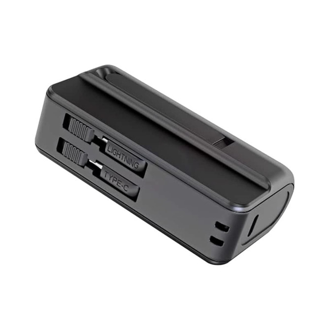A black power bank with slots for Lightning and Type-C connectors, featuring a built-in stand.