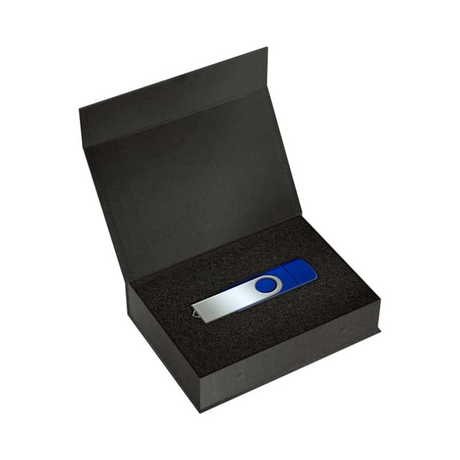 A blue and silver USB drive sits inside a black magnetic gift box lined with foam. The box is open.