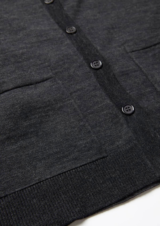 A dark charcoal knit cardigan featuring a button front and two front pockets. The fabric appears soft and textured.