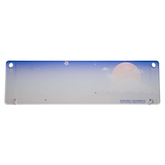 A long, translucent desk mat featuring a gradient from blue to white, with pink cherry blossom designs and a circular sun illustration.