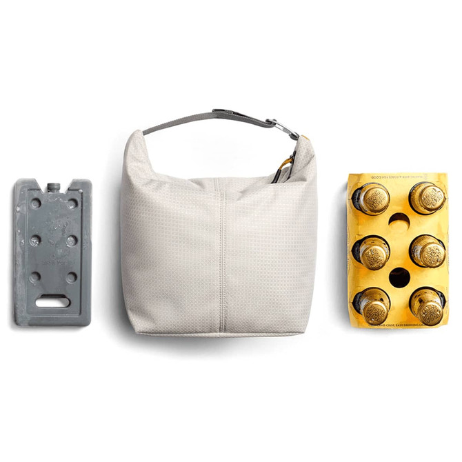 A cooler bag in light grey, accompanied by an ice pack and a four-pack of bottled drinks, showcasing its functionality.