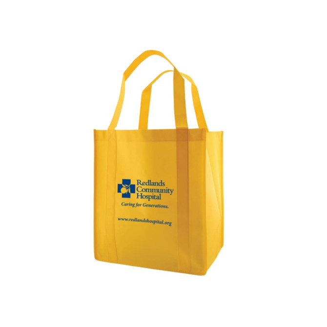 A large yellow reusable grocery bag with two handles and a logo on the front.