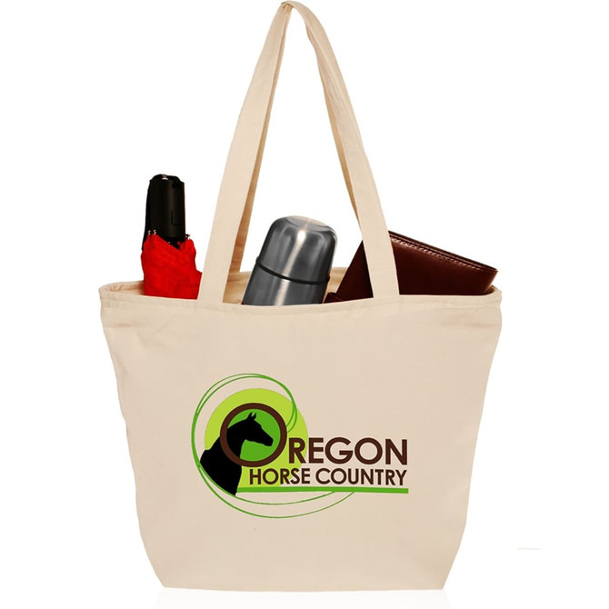 A cream cotton canvas tote bag with zipper closure, featuring a logo and holding a drink bottle, an umbrella, and a wallet.