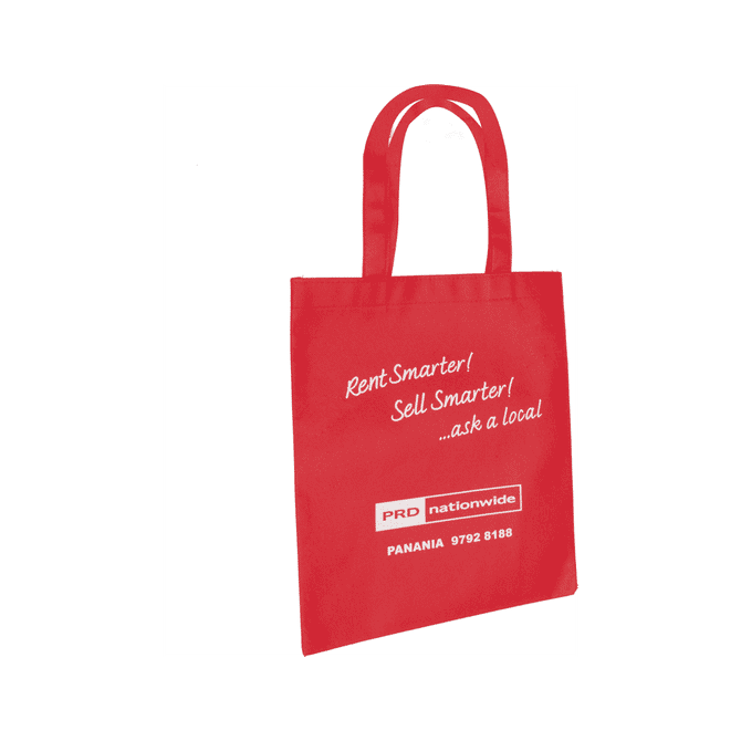 A red tote bag featuring sturdy handles and a branding logo. The bag has a simple, rectangular design.