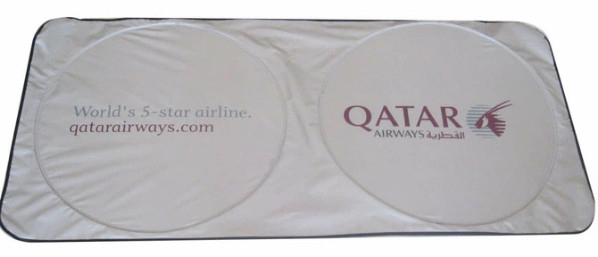 A foldable car sun visor in silver with two round sections and a logo on the side.