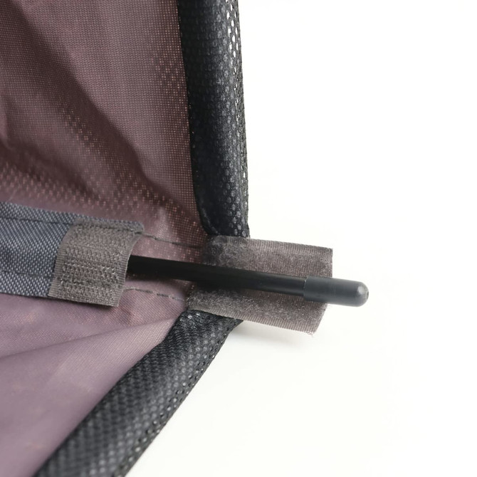 A close-up of a black laundry basket with wheels, featuring a mesh material and a pole secured in place.