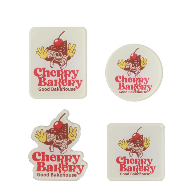 Acrylic fridge magnets in various shapes, featuring a design with a cherry and baked goods, in red and white.