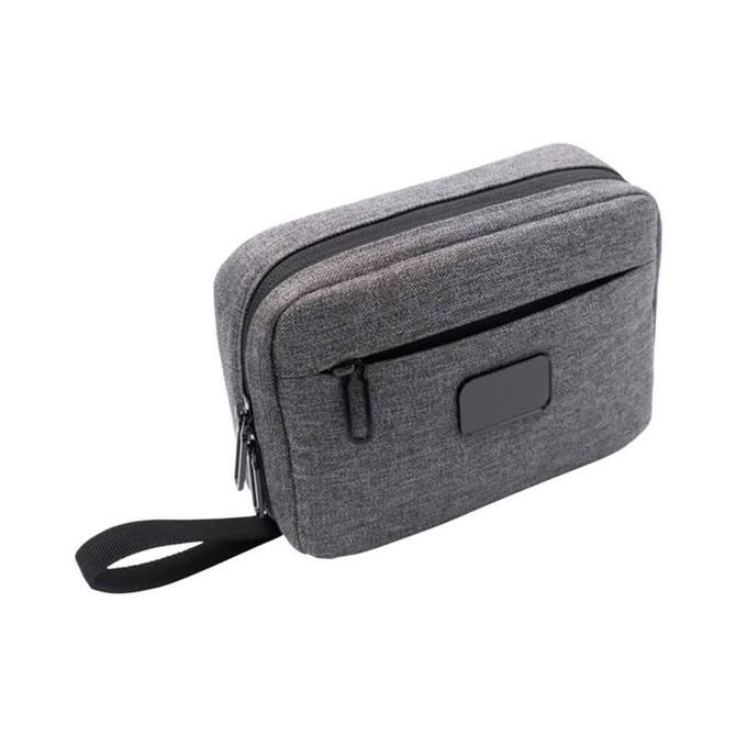 A grey toiletry bag with two zippered compartments and a side handle, featuring a logo on the front.