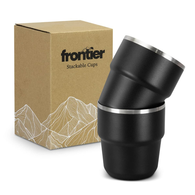 A set of two stackable cups in black with silver rims, presented next to a branded cardboard box.