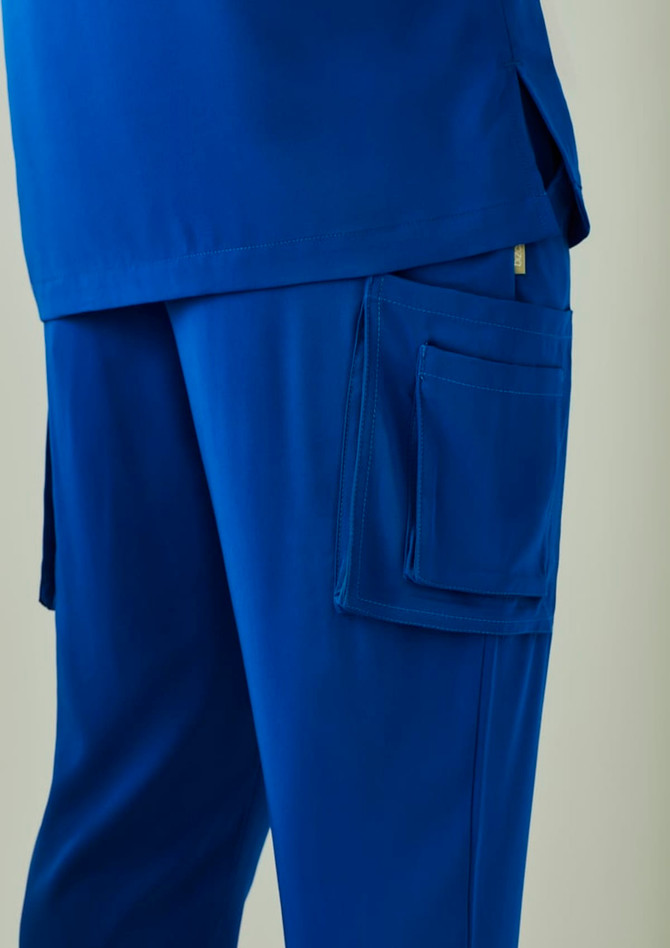 A pair of blue straight leg scrub pants featuring side pockets and a logo.