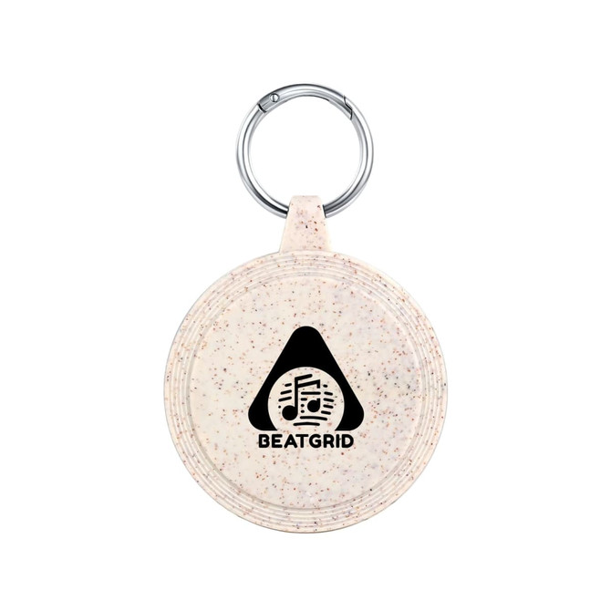 A round, speckled beige keychain with a metal ring and a logo featuring a triangle and musical notes.