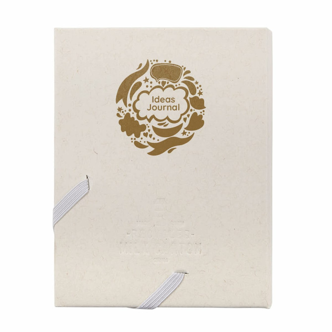 A cream-coloured journal with a decorative gold design and an elastic band closure. It features a logo on the cover.