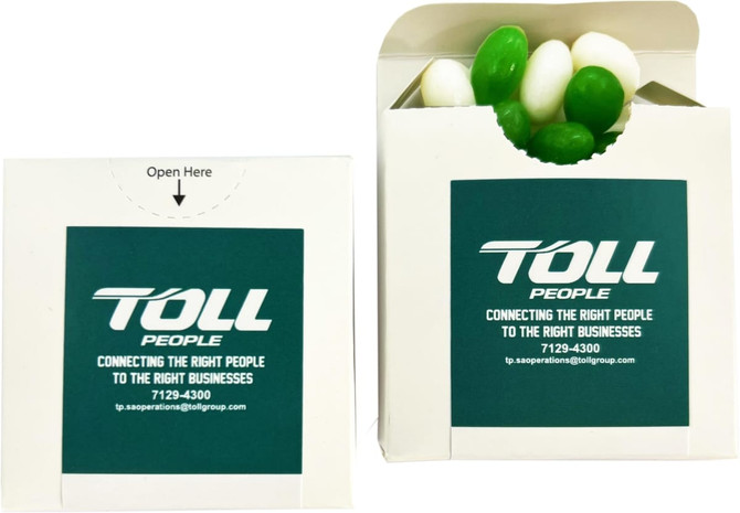 A flip lid cardboard box containing green and white jelly beans, featuring a logo on the front.