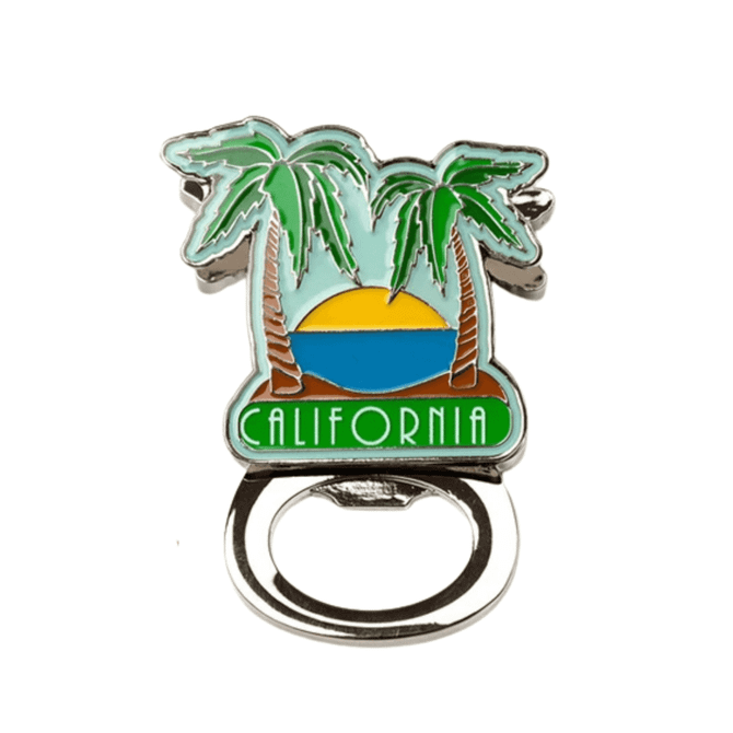 A drink bottle opener shaped like a palm tree scene with blue, green, and yellow colours. The design includes a logo.