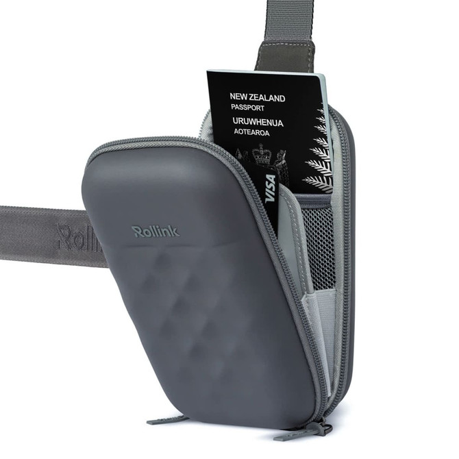 A grey Rollink Mini Bag Go with a passport and card visible inside, featuring a textured surface and a shoulder strap.