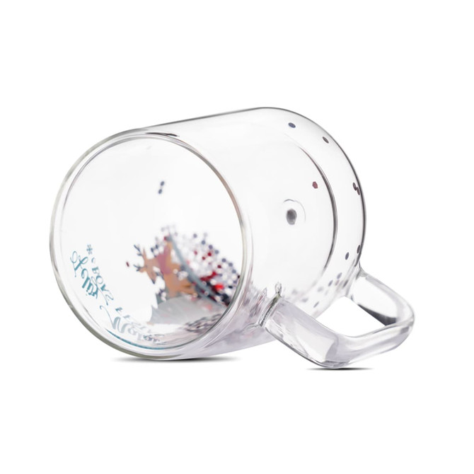 A clear glass Christmas-themed double wall mug with decorative confetti inside. It features a handle and a logo.