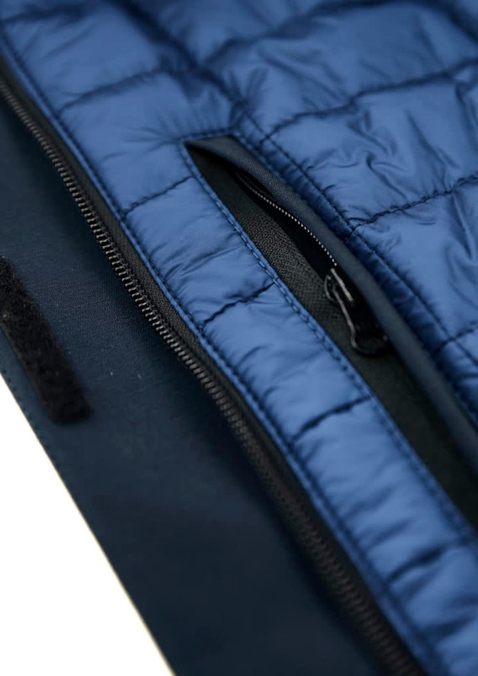 A men's jacket featuring navy blue insulation and a zippered pocket, designed as a rain jacket. It has a logo.