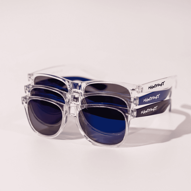 A pair of clear and blue sunglasses stacked on top of each other, featuring a logo on the side.