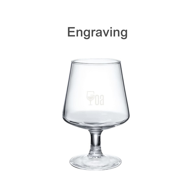 A clear glass brandy snifter with a wide bowl and a tall stem, featuring a logo on the front.