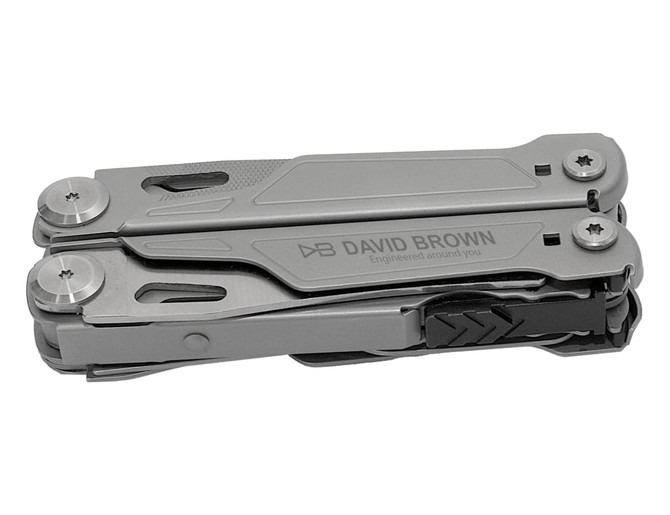 A grey multi-tool with various attachments, featuring a logo on its side. Compact design for easy portability.