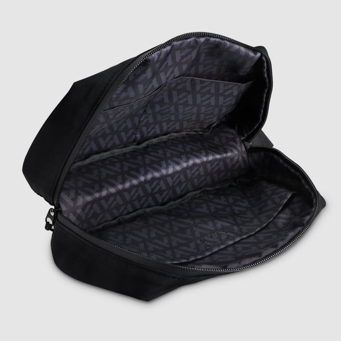 A black toiletry bag with a zippered opening, featuring multiple compartments and a patterned interior.
