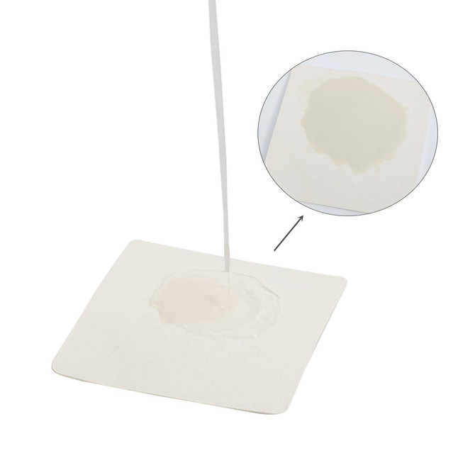 An absorbent paper coaster in a white square shape, showcasing liquid being absorbed in the centre.