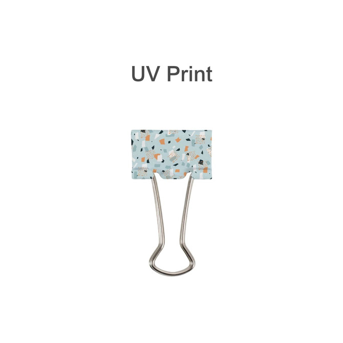 A binder clip featuring a light blue design with abstract patterns and silver metal arms.