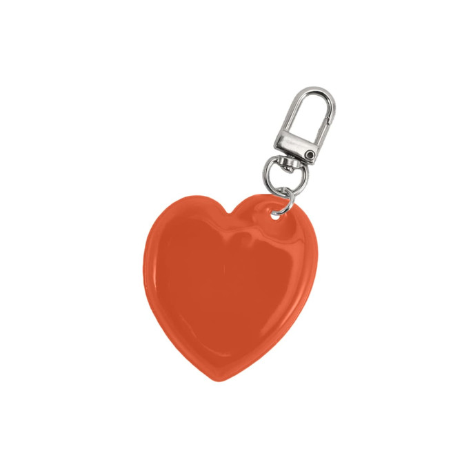 A heart-shaped keychain in bright orange with a metal clip for attachment. It has a glossy finish and a branding logo.