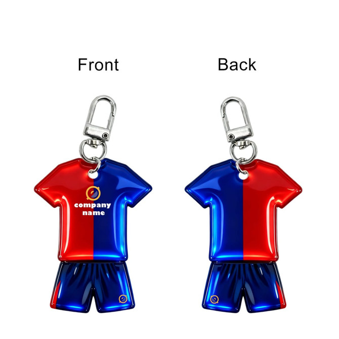 A reflective keychain in the shape of a blue and red sports shirt with matching shorts, featuring a logo.