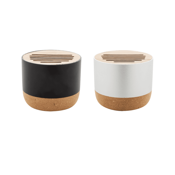 Two wireless speakers in black and white, featuring a cork base and a slotted wooden top, each with a logo.