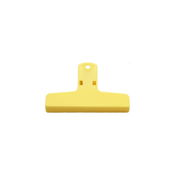 A yellow plastic magnetic clip with a flat design and a hole for hanging. It features a logo on the surface.
