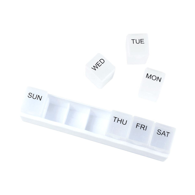 A white weekly pill organiser with compartments for each day of the week and removable labels for Monday to Sunday.