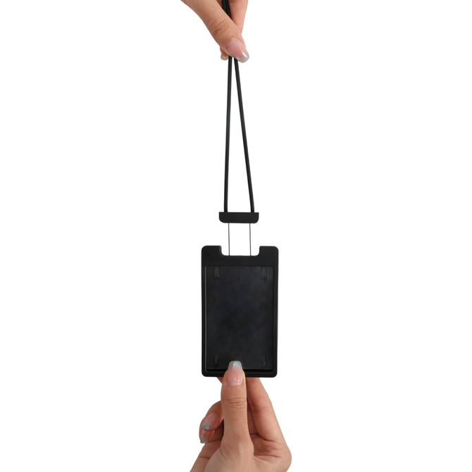 A black ABS retractable card holder with a silicone strap, being held by a hand.