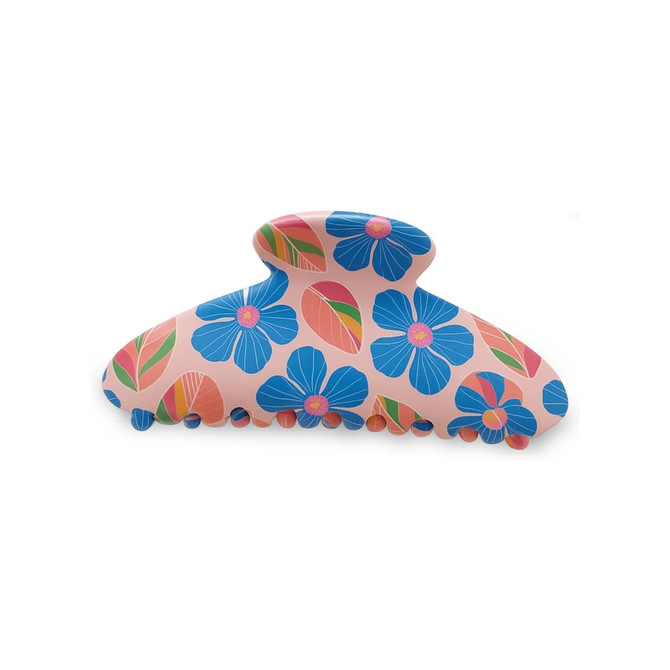 A hair clip in pink with blue flowers and leaves, featuring a curved design and detailed grip edges.